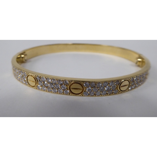 240 - A Cartier style 18ct gold diamond set 'Love' style bangle  stamped 750