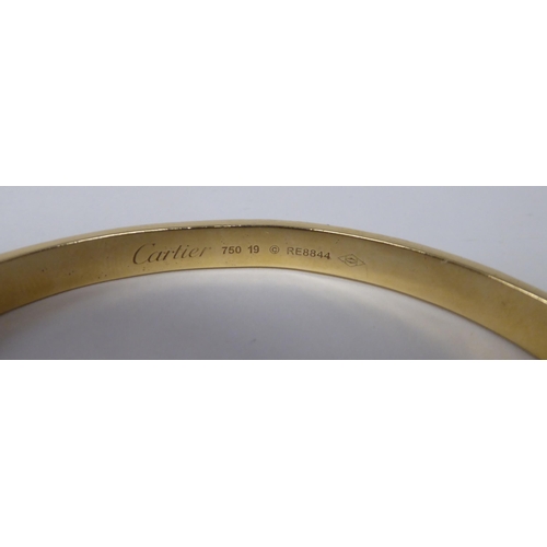 240 - A Cartier style 18ct gold diamond set 'Love' style bangle  stamped 750