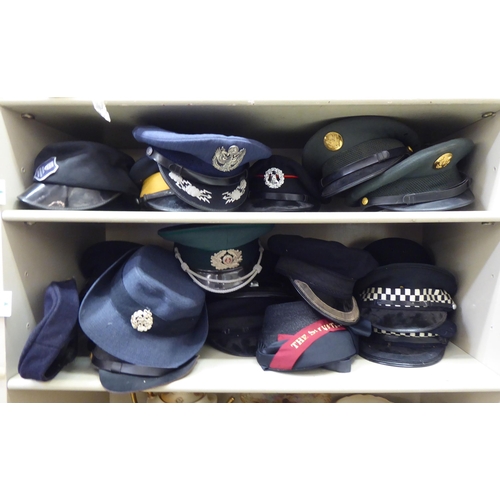 244 - Military and other, mainly 20thC headgear: to include peaked caps(Please Note: this lot is subject t... 