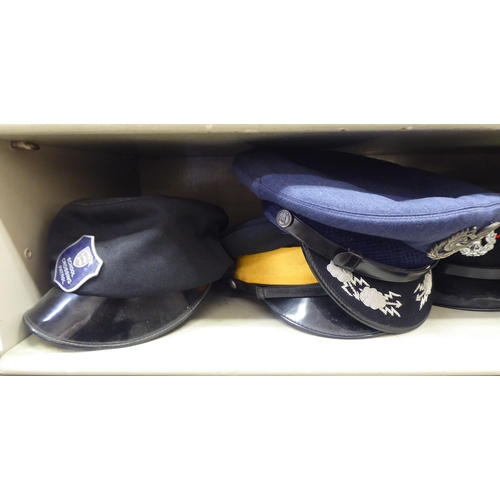 244 - Military and other, mainly 20thC headgear: to include peaked caps(Please Note: this lot is subject t... 