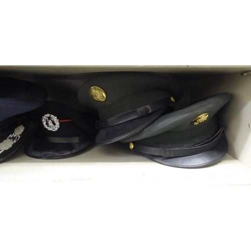 244 - Military and other, mainly 20thC headgear: to include peaked caps(Please Note: this lot is subject t... 