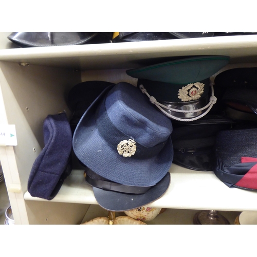 244 - Military and other, mainly 20thC headgear: to include peaked caps(Please Note: this lot is subject t... 