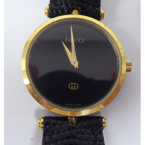 245 - A ladies Gucci black and yellow metal cased wristwatch, on a dedicated black lizard leather strap, b... 