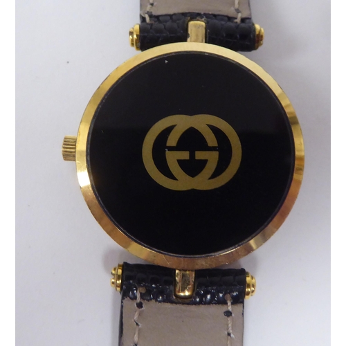 245 - A ladies Gucci black and yellow metal cased wristwatch, on a dedicated black lizard leather strap, b... 