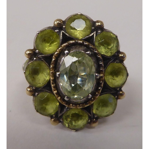 247 - A gold coloured metal peridot set cluster ring 