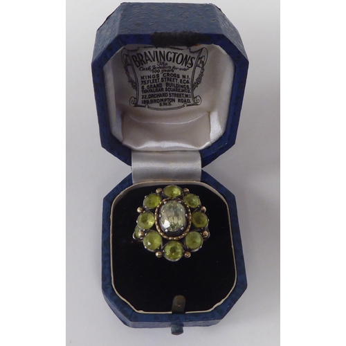 247 - A gold coloured metal peridot set cluster ring 