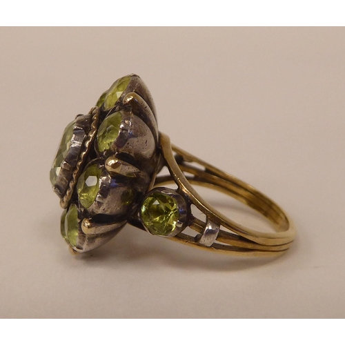 247 - A gold coloured metal peridot set cluster ring 