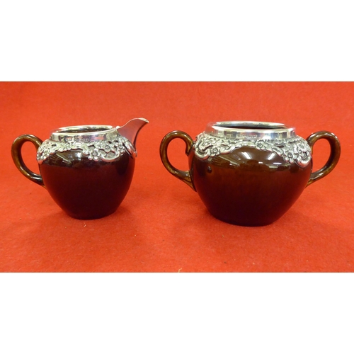 255 - Silver collectables: to include a three piece brown streaky glazed pottery tea set with silver mount... 