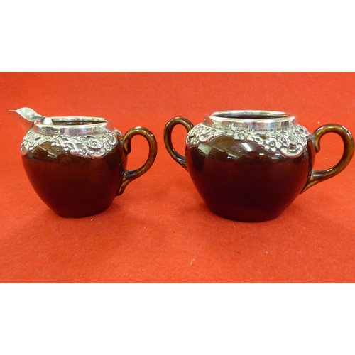 255 - Silver collectables: to include a three piece brown streaky glazed pottery tea set with silver mount... 