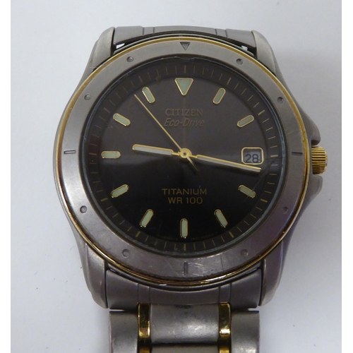 256 - A Citizen Eco-Drive titanium and yellow metal cased bracelet wristwatch, faced by a baton dial, inco... 