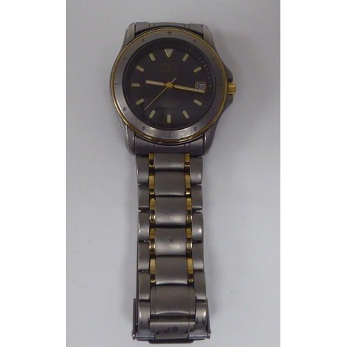 256 - A Citizen Eco-Drive titanium and yellow metal cased bracelet wristwatch, faced by a baton dial, inco... 