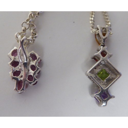 257 - Two variously set silver and coloured stone set pendants, on fine neckchains and ring bolt clasps