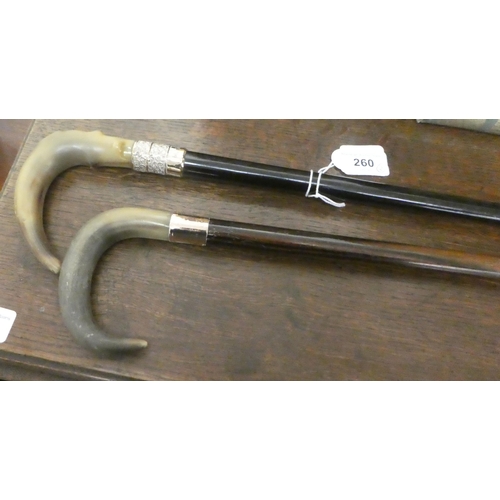 260 - Two early 20thC wooden walking canes with turned horn handles and pressed metal collars