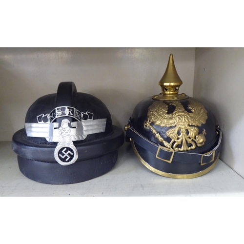 269 - Military and associated headgear: to include a German Third Reich pith helmet; a black lacquered and... 