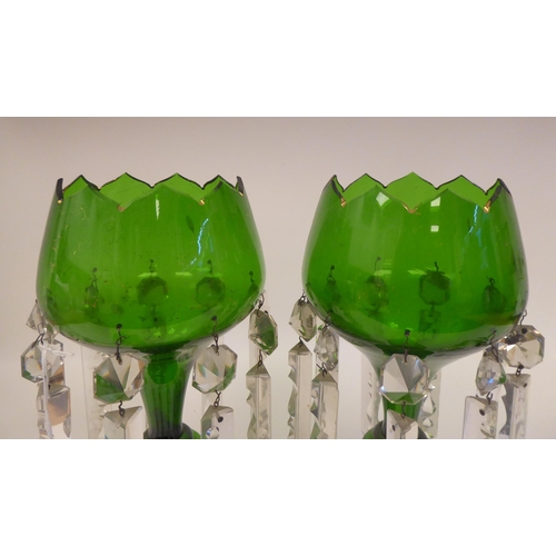 27 - A pair of late 19thC emerald green and gilded glass lustre vases, the bowls with castellated rims, s... 