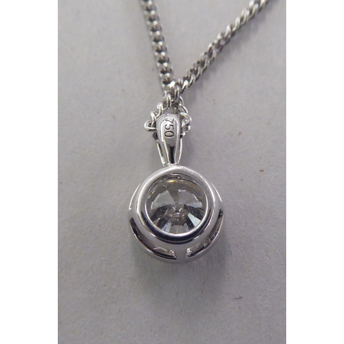 A white gold pendant, set with a single diamond, on a fine neckchain