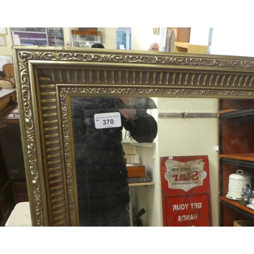 370 - A modern mirror, the bevelled plate set in a moulded, gilded frame  50