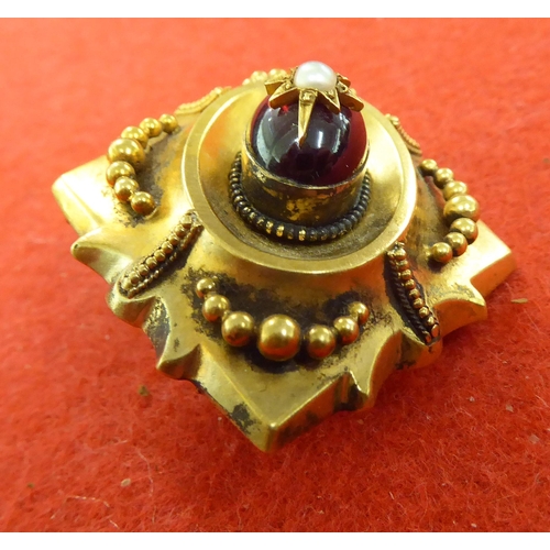 371 - A late Victorian yellow metal garnet and pearl set brooch