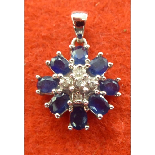 372 - A white gold coloured pendant, set with a diamond and sapphires