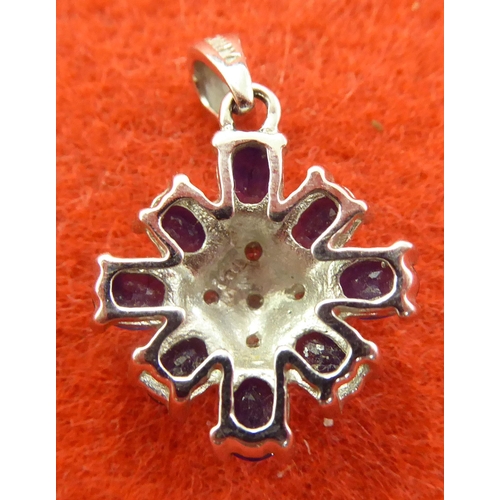 372 - A white gold coloured pendant, set with a diamond and sapphires