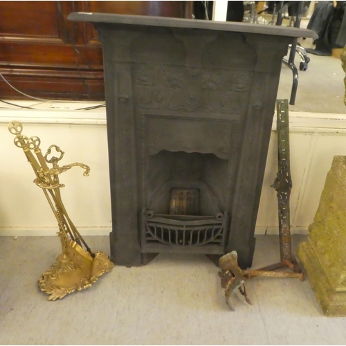 374 - An early 20thC cast iron fire surround and back, decorated in relief with flora  41