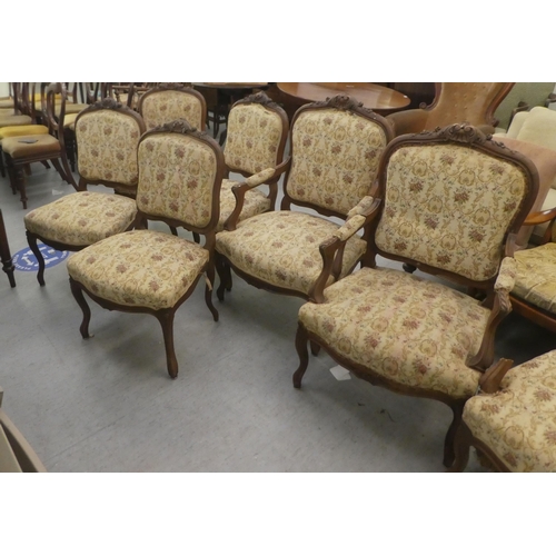 384 - A set of six early to mid 20thC French inspired mahogany framed showwood chairs, upholstered with fl... 