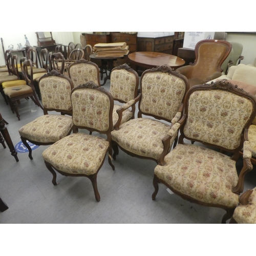 384 - A set of six early to mid 20thC French inspired mahogany framed showwood chairs, upholstered with fl... 