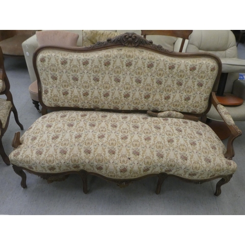 385 - An early to mid 20thC French inspired mahogany framed showwood two person open arm settee, upholster... 