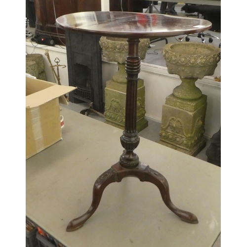 386 - A late 19thC mahogany pedestal table, raised on a fluted column and carved tripod base  28