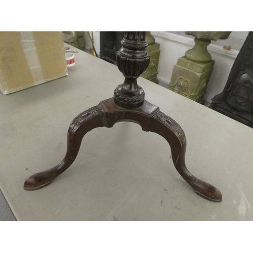 386 - A late 19thC mahogany pedestal table, raised on a fluted column and carved tripod base  28