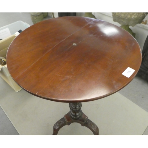 386 - A late 19thC mahogany pedestal table, raised on a fluted column and carved tripod base  28