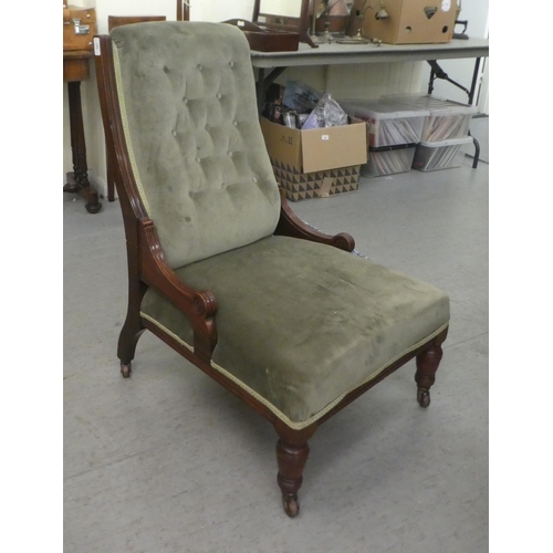 387 - An Edwardian mahogany showwood framed nursing chair, later part button upholstered in green fabric, ... 