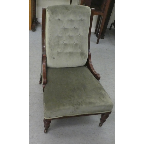 387 - An Edwardian mahogany showwood framed nursing chair, later part button upholstered in green fabric, ... 