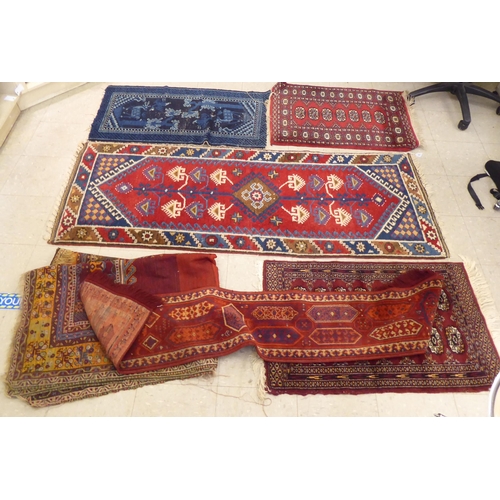 393 - Rugs: to include a Persian runner, decorated with repeating diamond formation and stylised designs&n... 