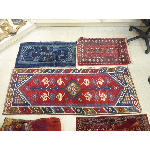 393 - Rugs: to include a Persian runner, decorated with repeating diamond formation and stylised designs&n... 