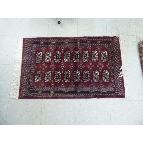 393 - Rugs: to include a Persian runner, decorated with repeating diamond formation and stylised designs&n... 