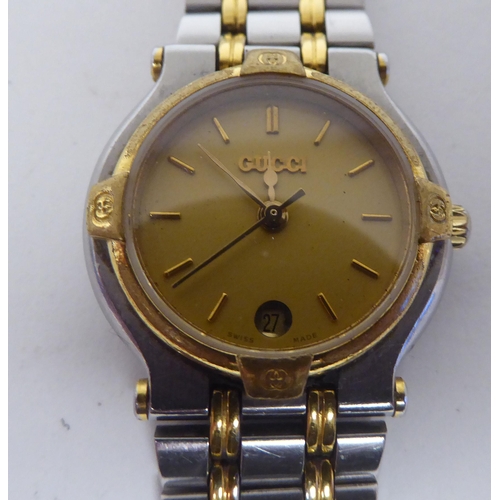 395 - A lady's Gucci 900L  bi-coloured stainless steel cased  bracelet wristwatch, faced by a gilded baton... 