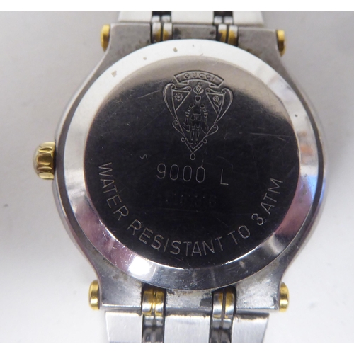 395 - A lady's Gucci 900L  bi-coloured stainless steel cased  bracelet wristwatch, faced by a gilded baton... 