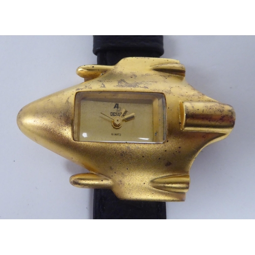 396 - A Gucci Accent on Design Jet Plane quartz wristwatch, the gilded case fashioned as a jet plane, on a... 