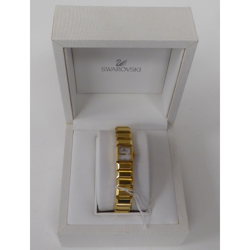 412 - A lady's Swarovski Baguette gilded stainless steel cased, quartz bracelet wristwatch  boxed