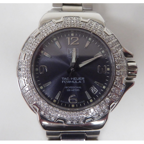 430 - A lady's Tag Heuer Fomula 1 diamond encrusted quartz stainless steel cased bracelet wristwatch, face... 