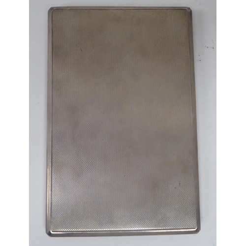 436 - A Dunhill silver folding cigarette case with engine turned decoration and a sliding clasp  Lond... 