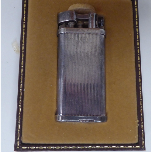 437 - A vintage Dunhill silver plated cased, petrol filled cigarette lighter  boxed