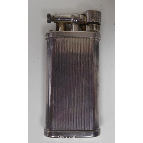 437 - A vintage Dunhill silver plated cased, petrol filled cigarette lighter  boxed