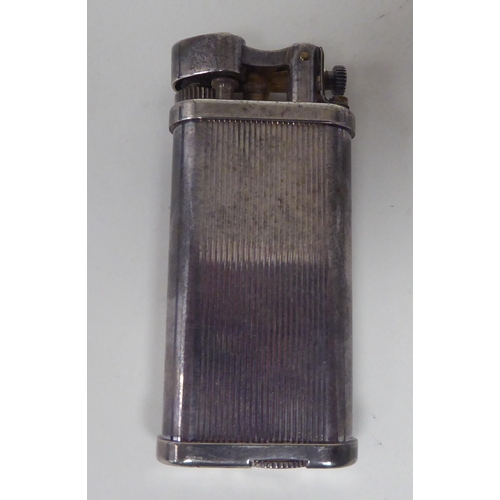 437 - A vintage Dunhill silver plated cased, petrol filled cigarette lighter  boxed