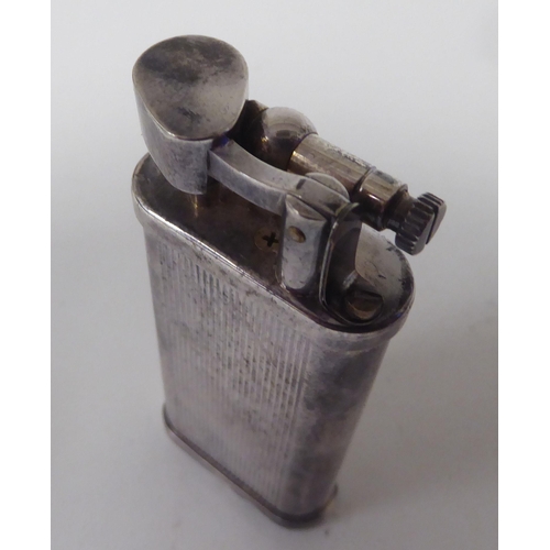 437 - A vintage Dunhill silver plated cased, petrol filled cigarette lighter  boxed