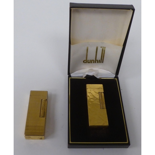 438 - Two similar Dunhill textured gold plated cased flip-top, gas filled cigarette lighters  one box... 