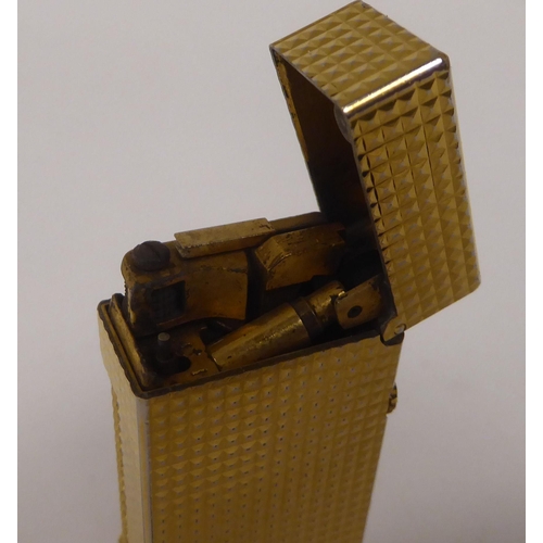 438 - Two similar Dunhill textured gold plated cased flip-top, gas filled cigarette lighters  one box... 