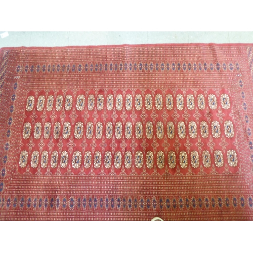 84 - A Bokhara rug, decorated with three columns of twenty guls, on a red ground  50