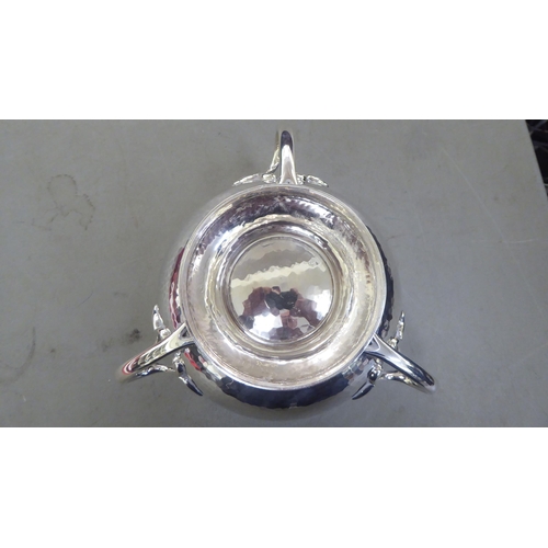 63 - A post modern period spot-hammered silver rose bowl of bulbous form with an inverted rim and three a... 